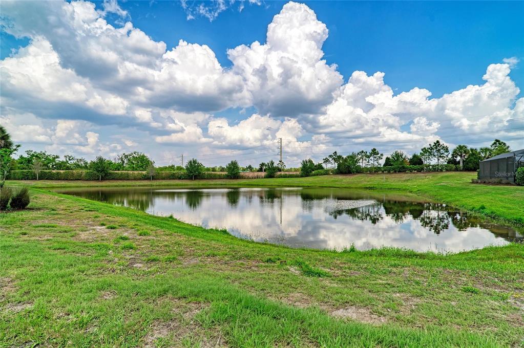 7013 Hanover Court Lakewood Ranch, FL 34202 - Photo 42 of 64 a view of a lake with a big yard