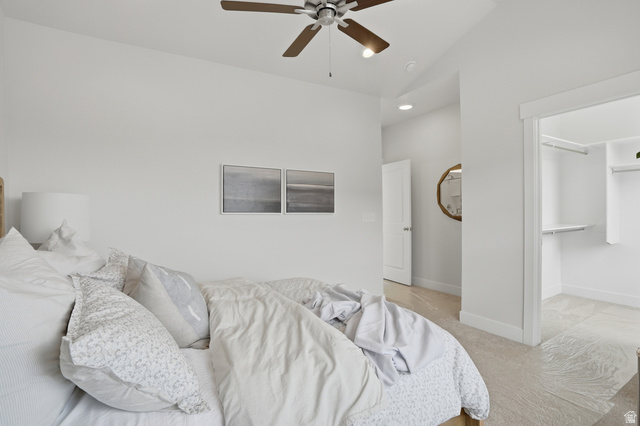 7338 South Seven Tree Lane, Unit 75 Midvale, UT 84047 - Photo 16 of 30 Bedroom featuring vaulted ceiling, a spacious closet, a ceiling fan, light colored carpet, and recessed lighting