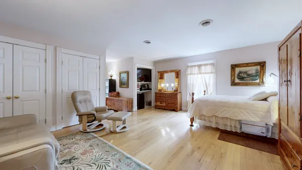 a spacious bedroom with a bed and furniture