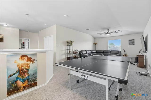 a kitchen with stainless steel appliances kitchen island granite countertop a sink and a refrigerator
