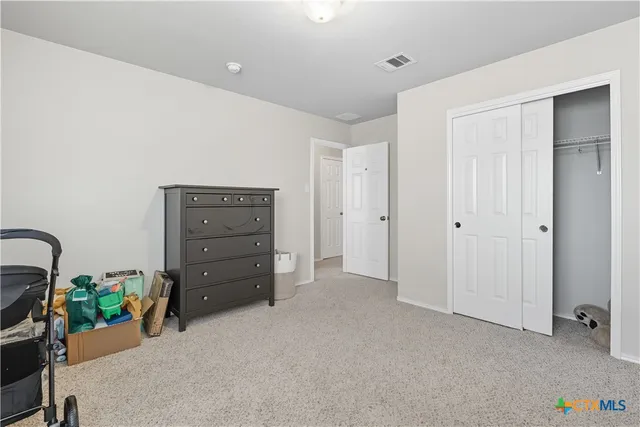 a view of an empty room with closet