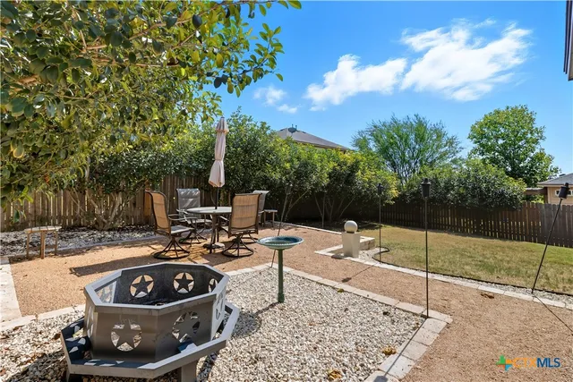 a view of a backyard with sitting area