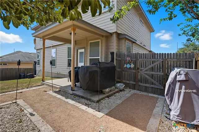 a view of a chairs and table in backyard