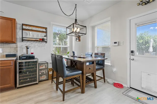 a dining room with furniture and window