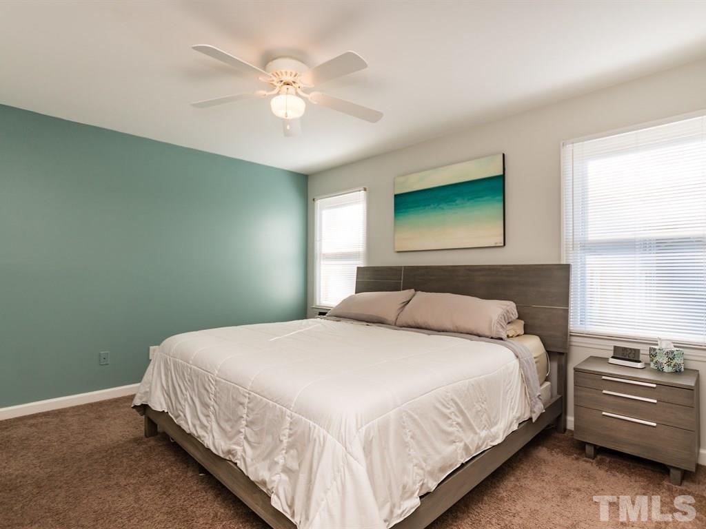 4104 Wingate Drive Raleigh, NC 27609 - Photo 14 of 24 a bedroom with a bed and a ceiling fan