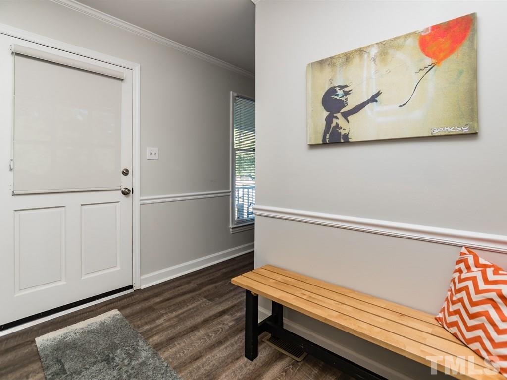 4104 Wingate Drive Raleigh, NC 27609 - Photo 3 of 24 a hallway with painting on the wall and a window