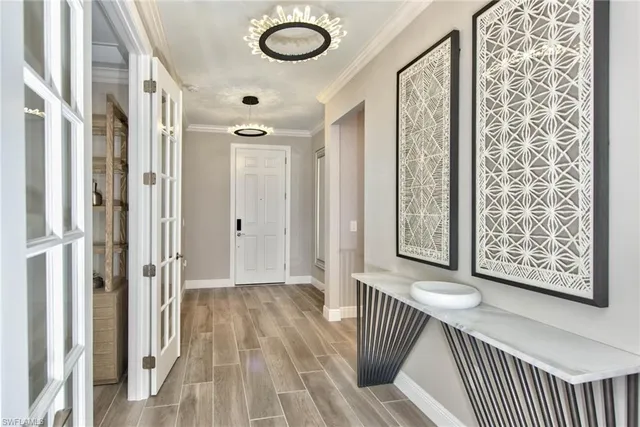 a view of a hallway with wooden floor and staircase