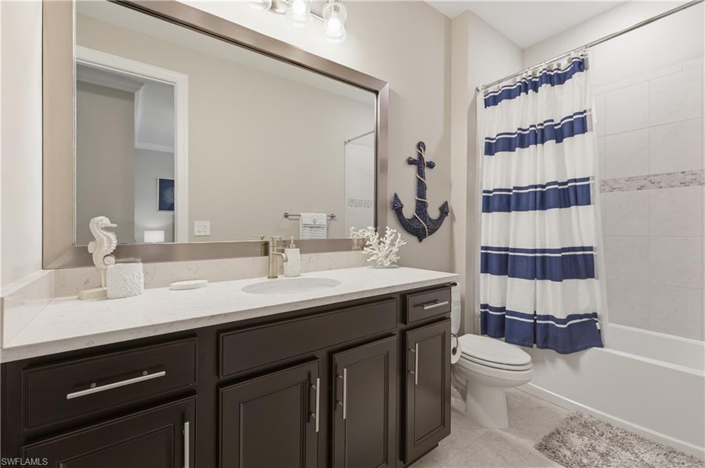 9761 Willet Court Naples, FL 34120 - Photo 12 of 44 a bathroom with a sink a toilet and shower