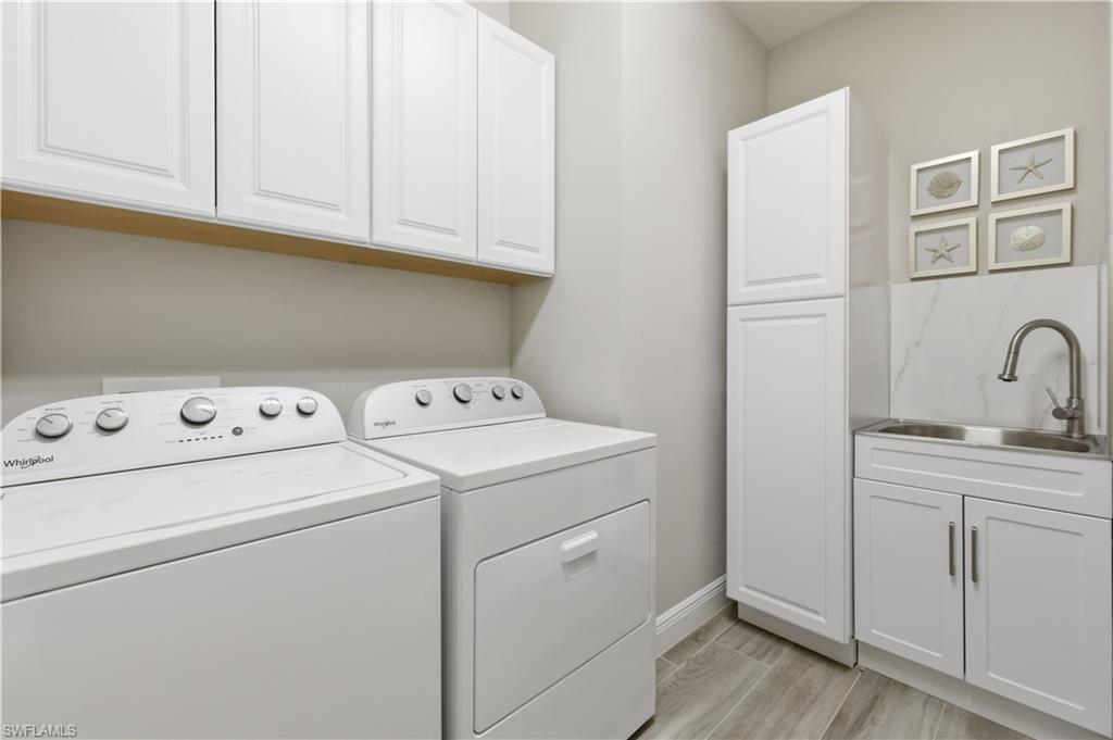 9761 Willet Court Naples, FL 34120 - Photo 13 of 44 a utility room with dryer and washer
