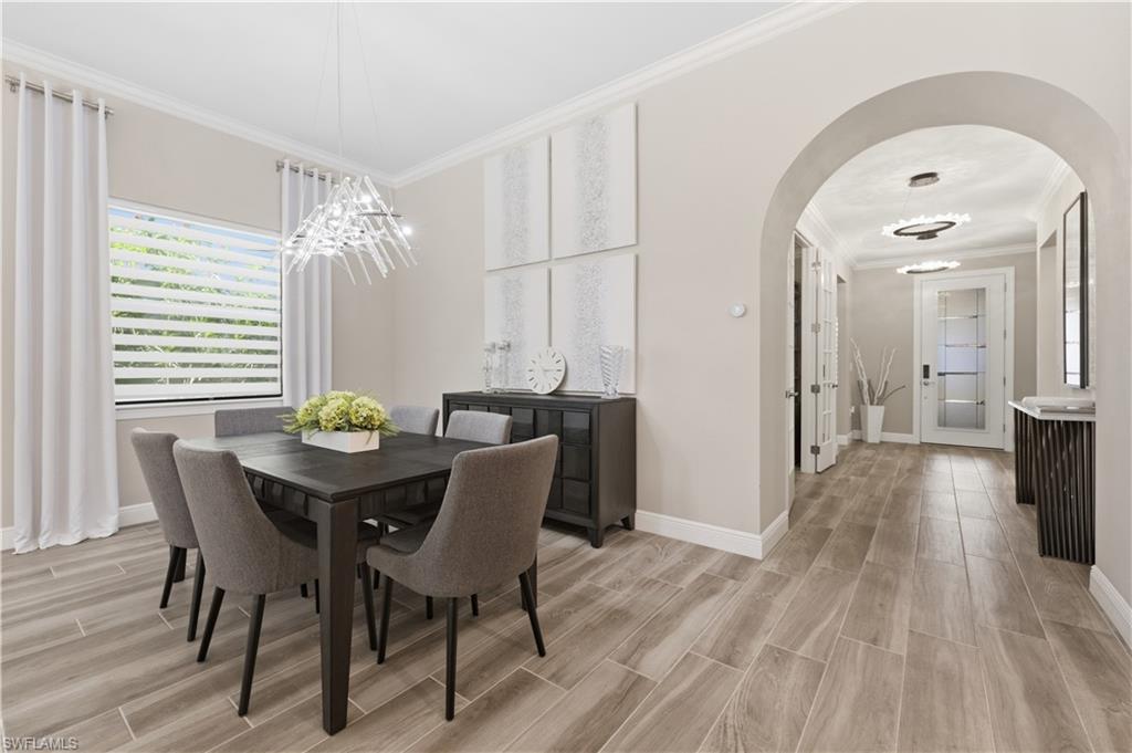 9761 Willet Court Naples, FL 34120 - Photo 15 of 44 a view of a dining room with furniture and wooden floor