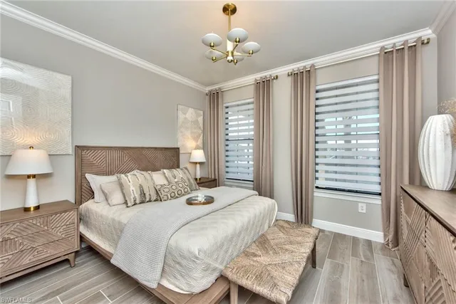 a bedroom with a bed and a chandelier