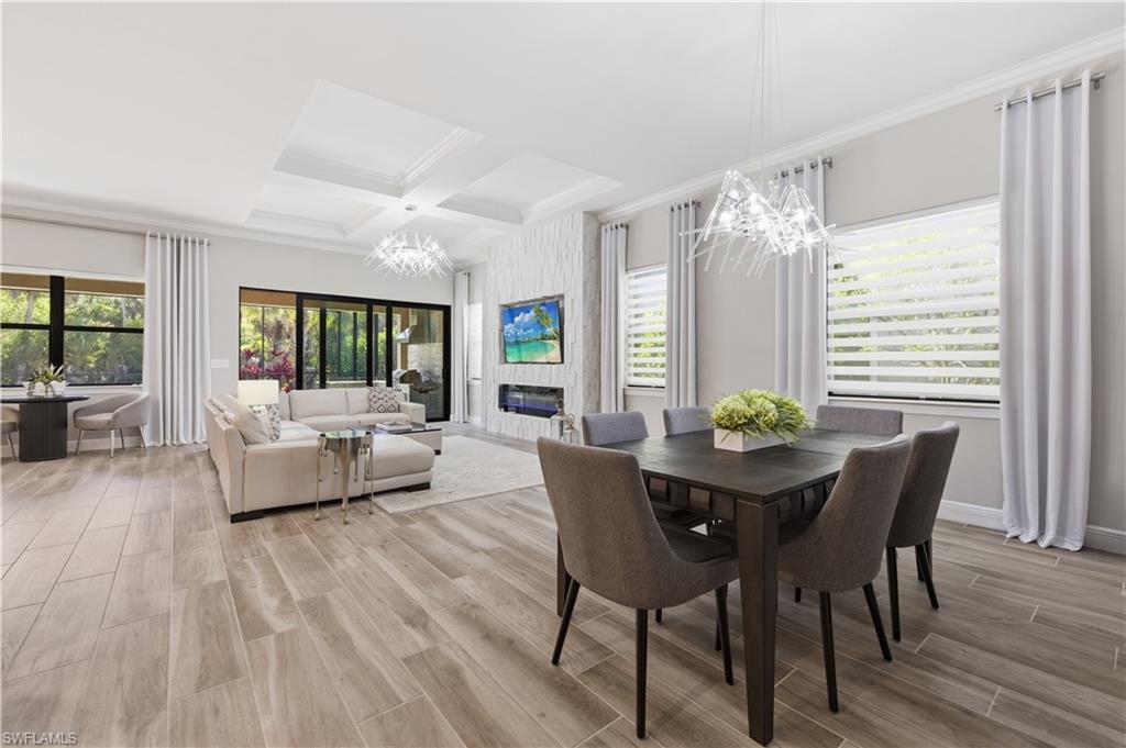 9761 Willet Court Naples, FL 34120 - Photo 16 of 44 a view of a dining room with furniture and wooden floor