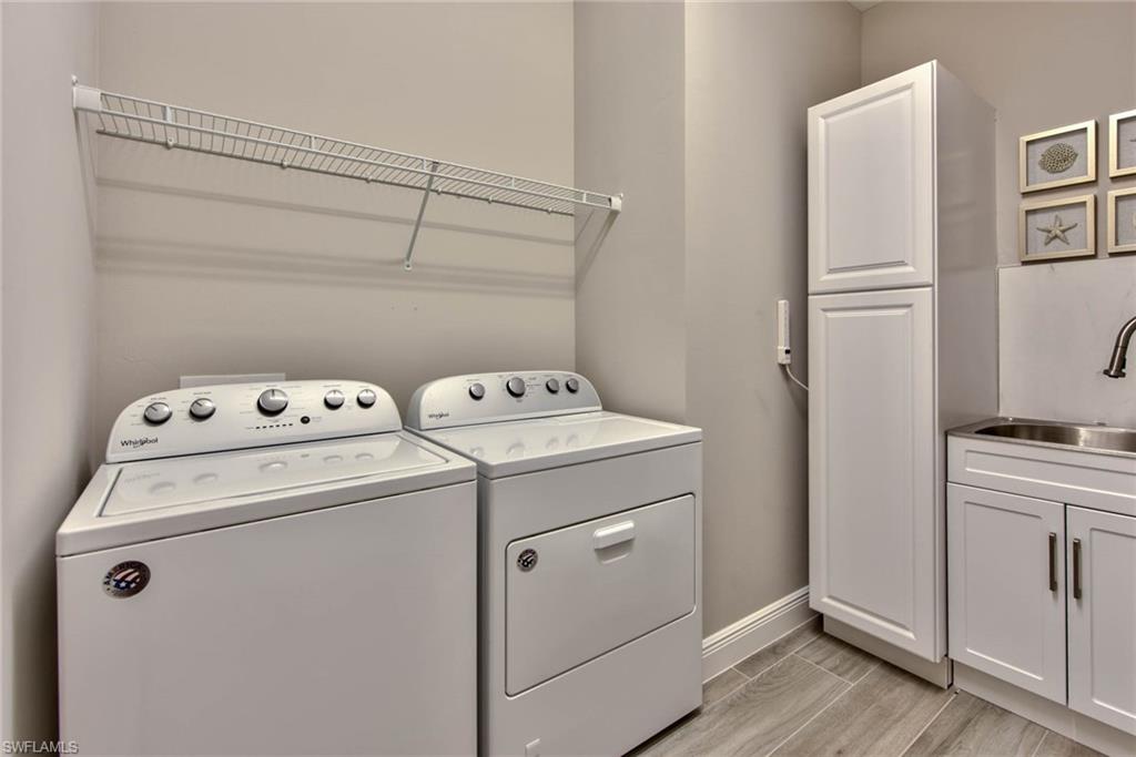 9761 Willet Court Naples, FL 34120 - Photo 20 of 34 a utility room with dryer and washer