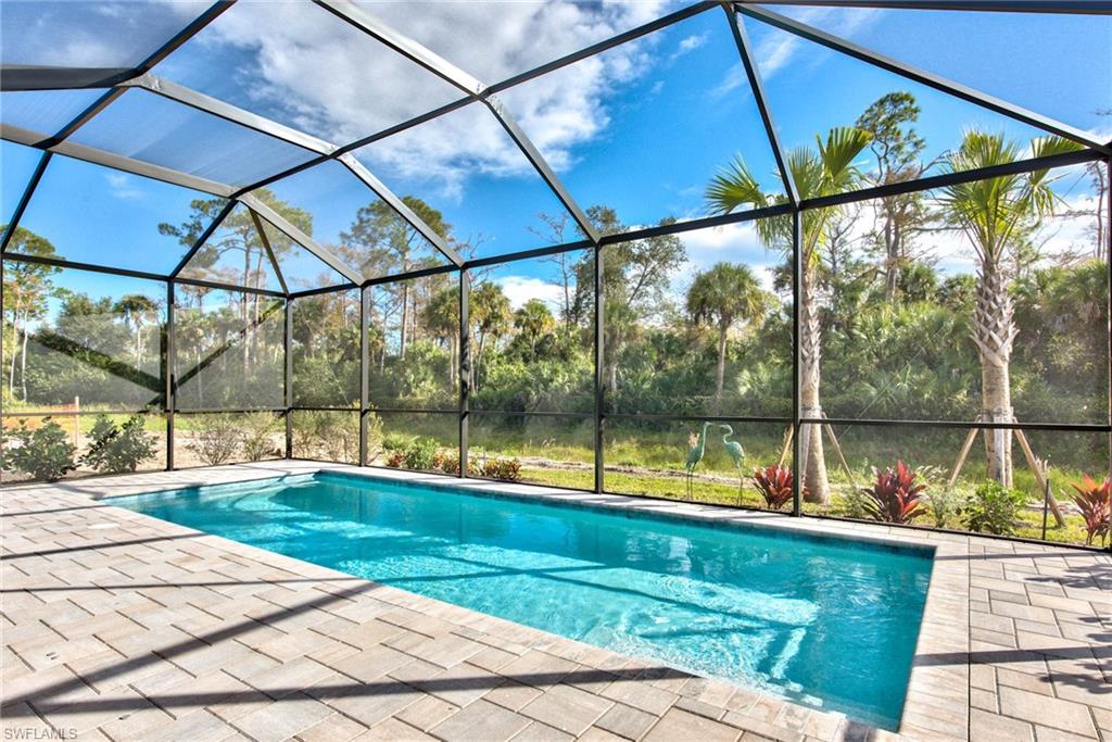 9761 Willet Court Naples, FL 34120 - Photo 2 of 34 a view of swimming pool with a patio