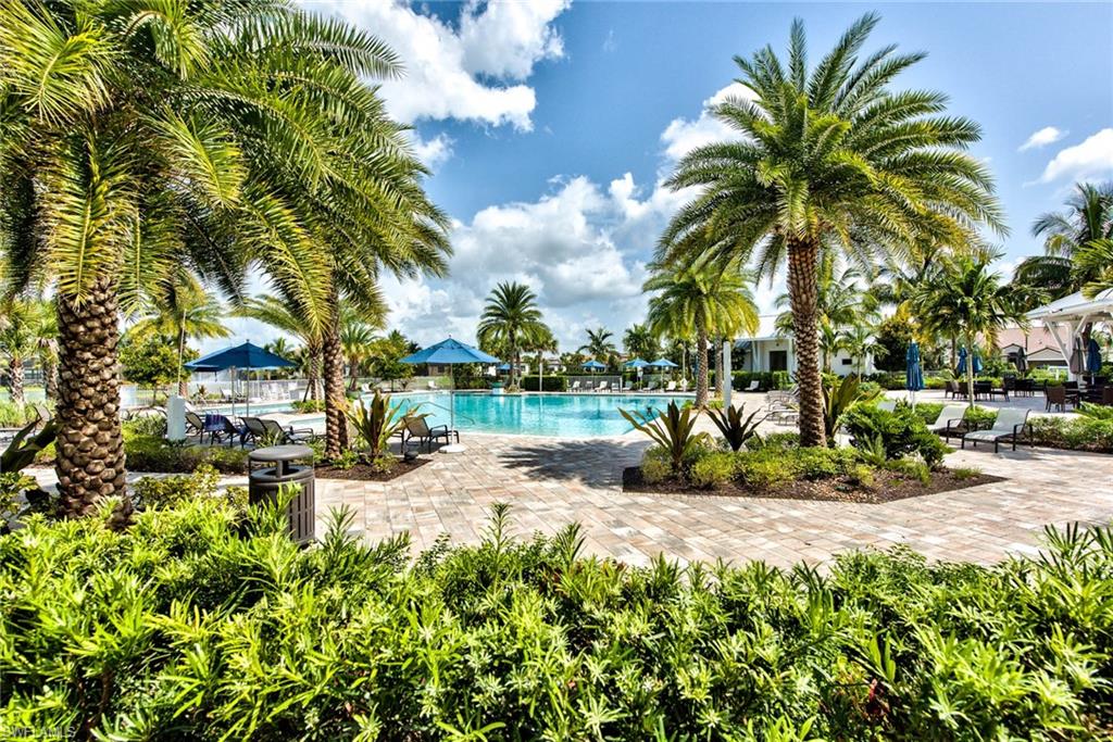 9761 Willet Court Naples, FL 34120 - Photo 22 of 34 a view of a garden with a bench and trees