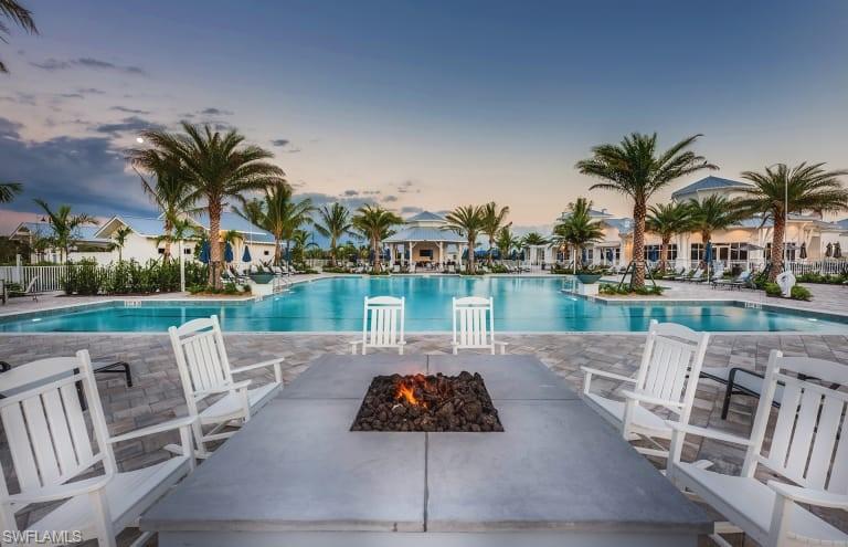 9761 Willet Court Naples, FL 34120 - Photo 23 of 34 a view of a swimming pool and lounge chair