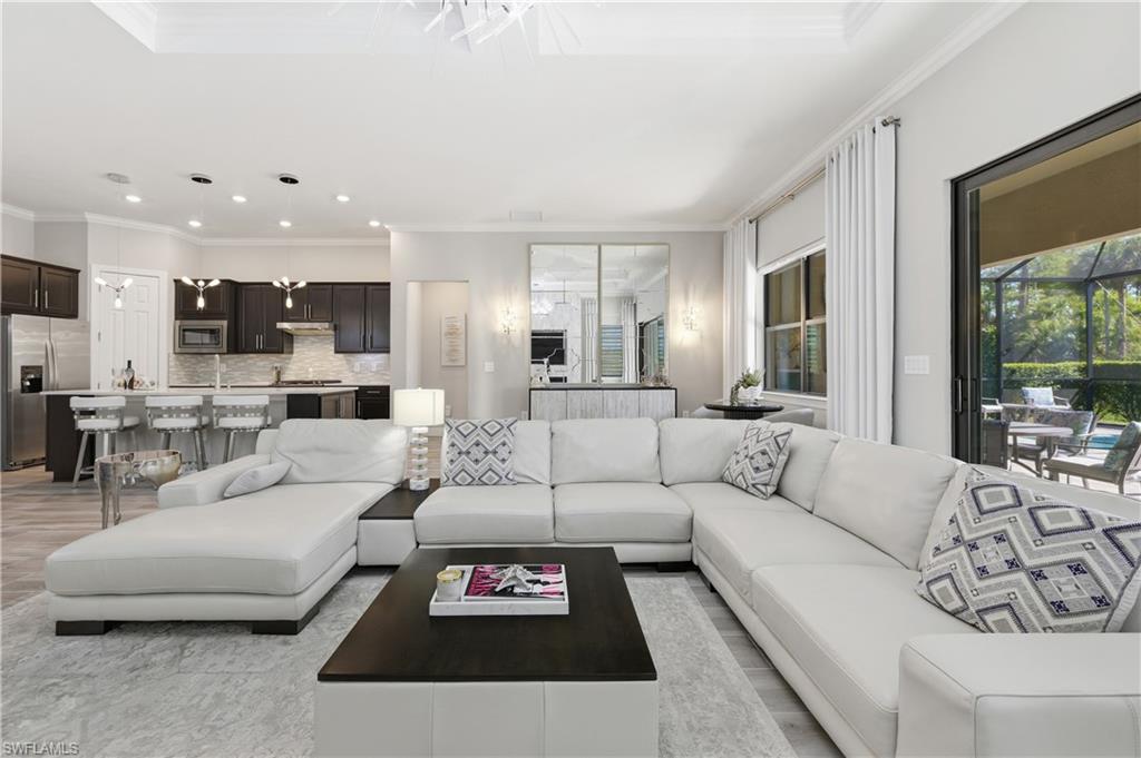 9761 Willet Court Naples, FL 34120 - Photo 23 of 44 a living room with furniture and a large window