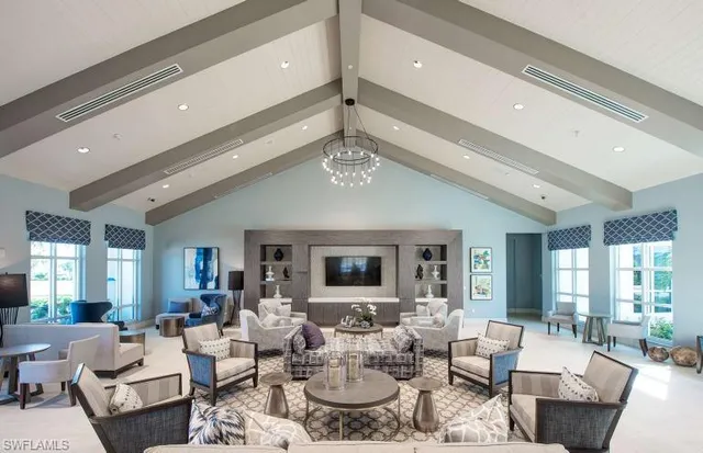 a living room with furniture chandelier and view of kitchen