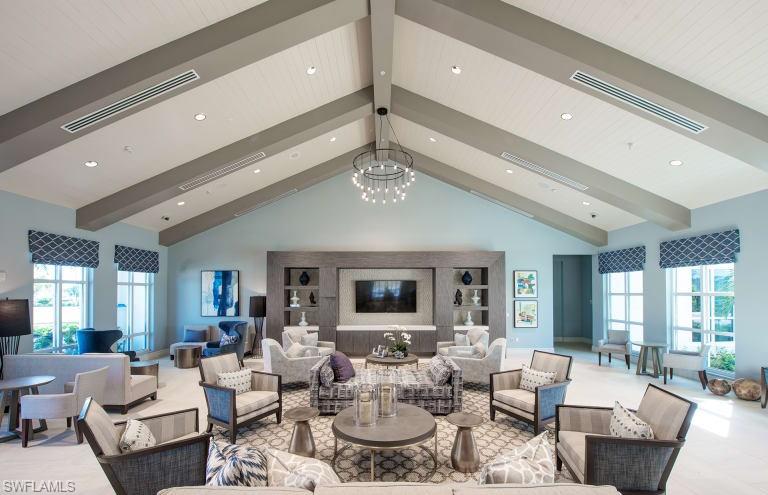 9761 Willet Court Naples, FL 34120 - Photo 25 of 34 a living room with furniture chandelier and view of kitchen