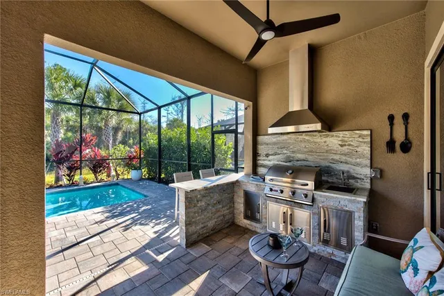 a living room with furniture a fireplace and a floor to ceiling window