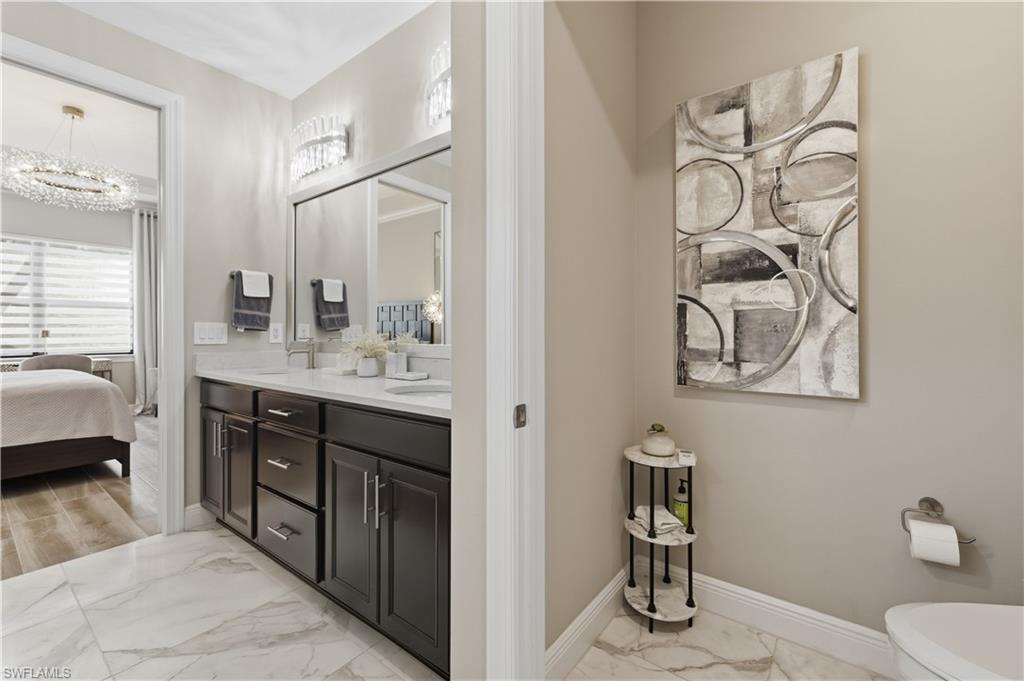 9761 Willet Court Naples, FL 34120 - Photo 30 of 44 a en suite bathroom with a double vanity sink and a mirror
