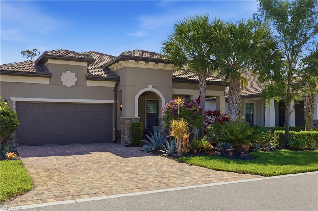 9761 Willet Court Naples, FL 34120 - Photo 3 of 44 a front view of a house with a garden