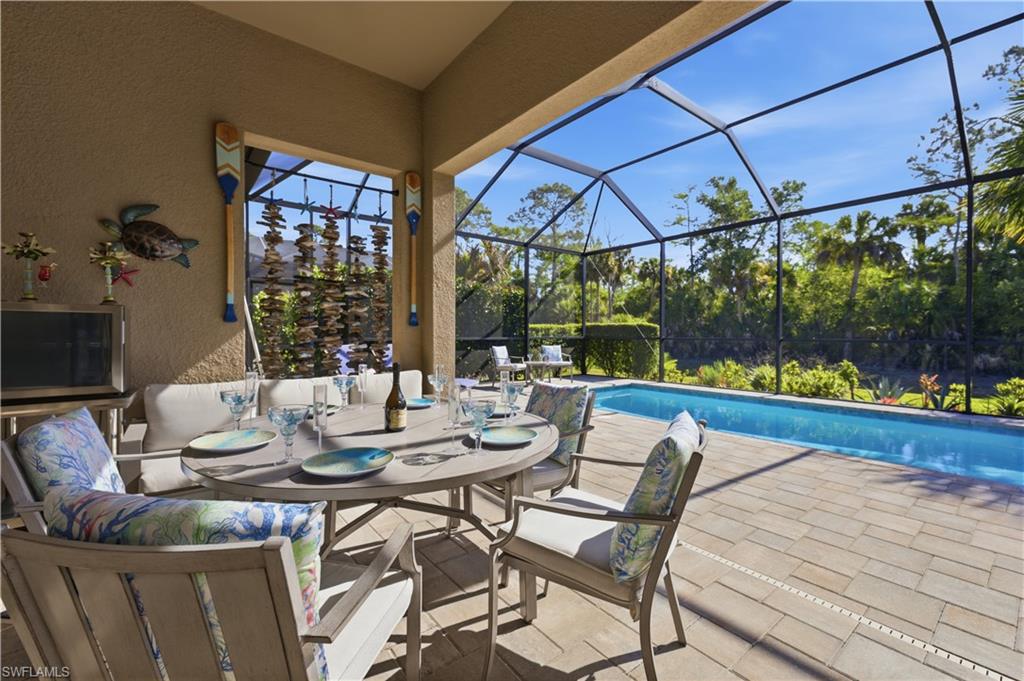 9761 Willet Court Naples, FL 34120 - Photo 31 of 44 a table and chairs in front of a building
