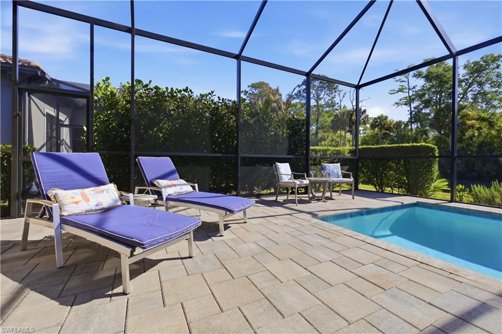9761 Willet Court Naples, FL 34120 - Photo 36 of 44 a view of a swimming pool with a patio