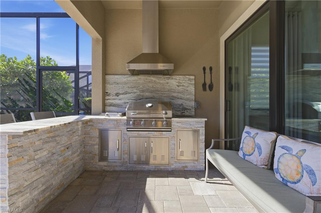 9761 Willet Court Naples, FL 34120 - Photo 37 of 44 a living room with furniture and a fireplace