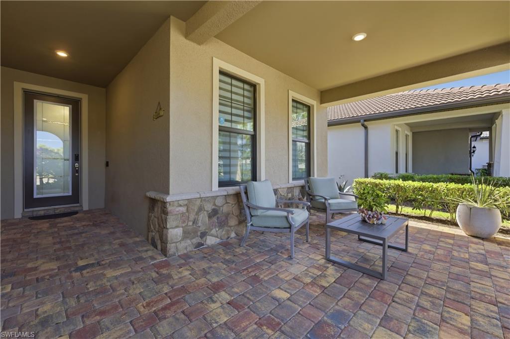9761 Willet Court Naples, FL 34120 - Photo 4 of 44 a living room with furniture and a potted plant