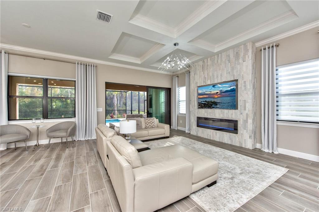 9761 Willet Court Naples, FL 34120 - Photo 6 of 34 a living room with furniture and a fireplace