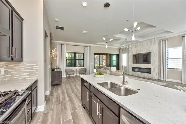a kitchen with stainless steel appliances granite countertop a sink and a stove