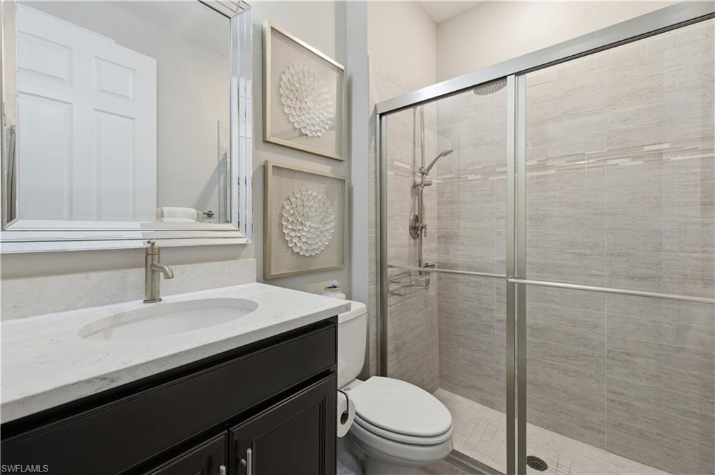 9761 Willet Court Naples, FL 34120 - Photo 8 of 44 a bathroom with a sink a toilet and shower