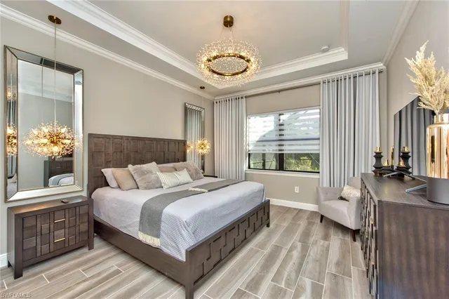 a bedroom with a bed and a chandelier