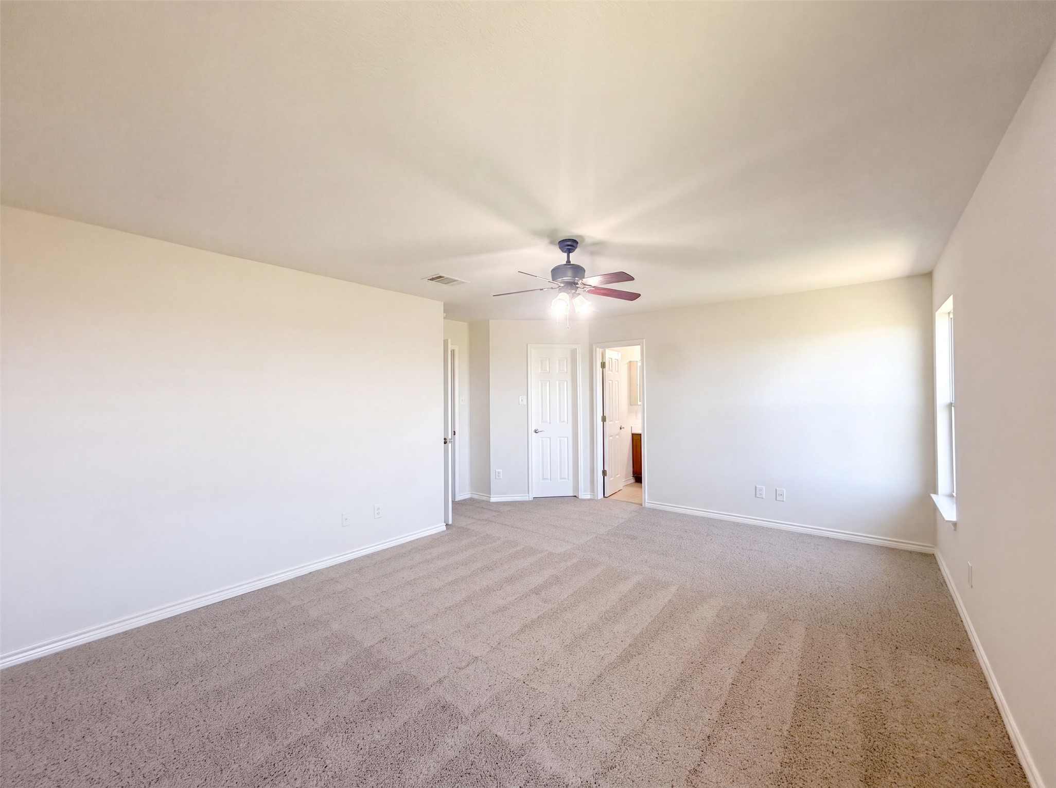 40 Verde Ranch Loop Leander, TX 78641 - Photo 4 of 20 A spacious, naturally illuminated room featuring neutral carpeting and a convenient ceiling fan.