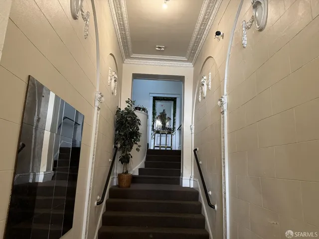 a view of a entryway door with hallway and wooden floor
