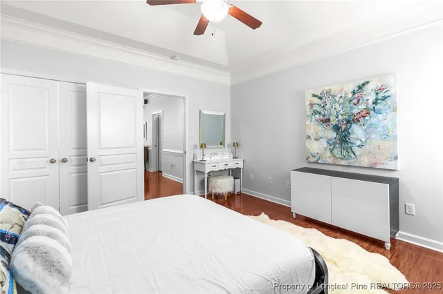 a bedroom with a large bed and a chandelier