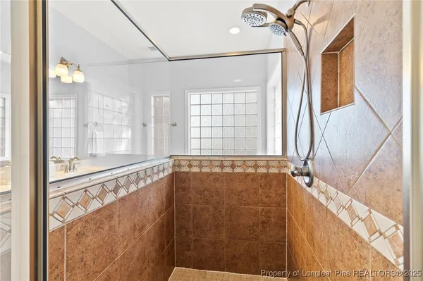 a bathroom with a sink a light fixture and a mirror