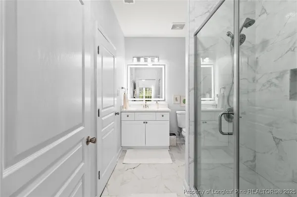 a bathroom with a shower and a shower head
