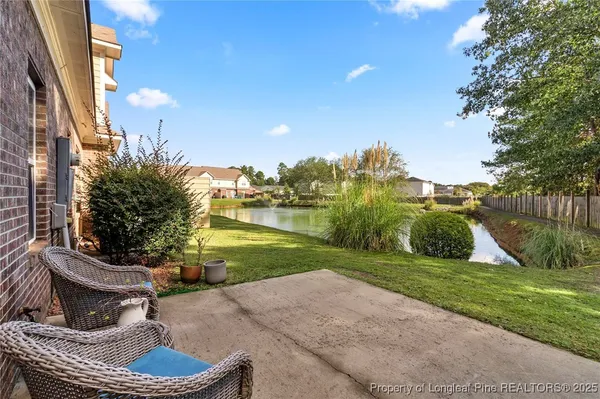 a view of a lake with houses in the back