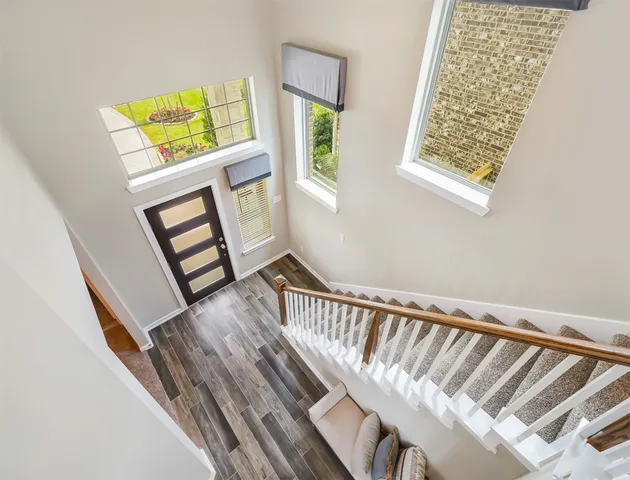a view of staircase with white walls and a window