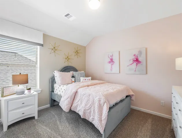 a bedroom with a bed and a cabinet