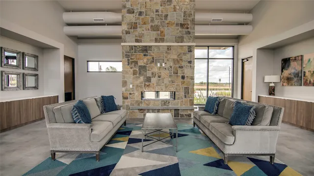 a living room with furniture and a floor to ceiling window