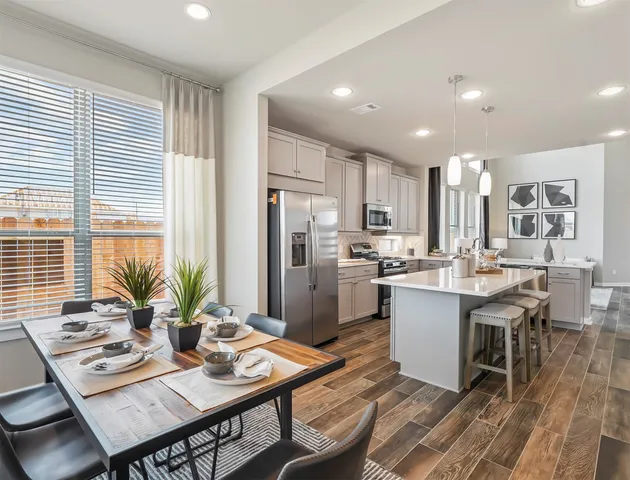 a kitchen with a table and chairs in it