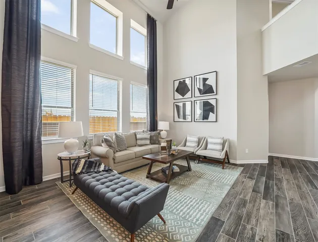 a living room with furniture and wooden floor