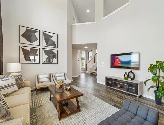 a living room with furniture and a painting on the wall