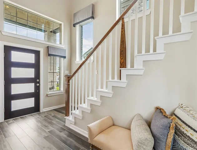 a view of entryway and hall with wooden floor
