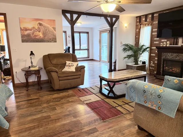 a living room with furniture a flat screen tv and a fireplace