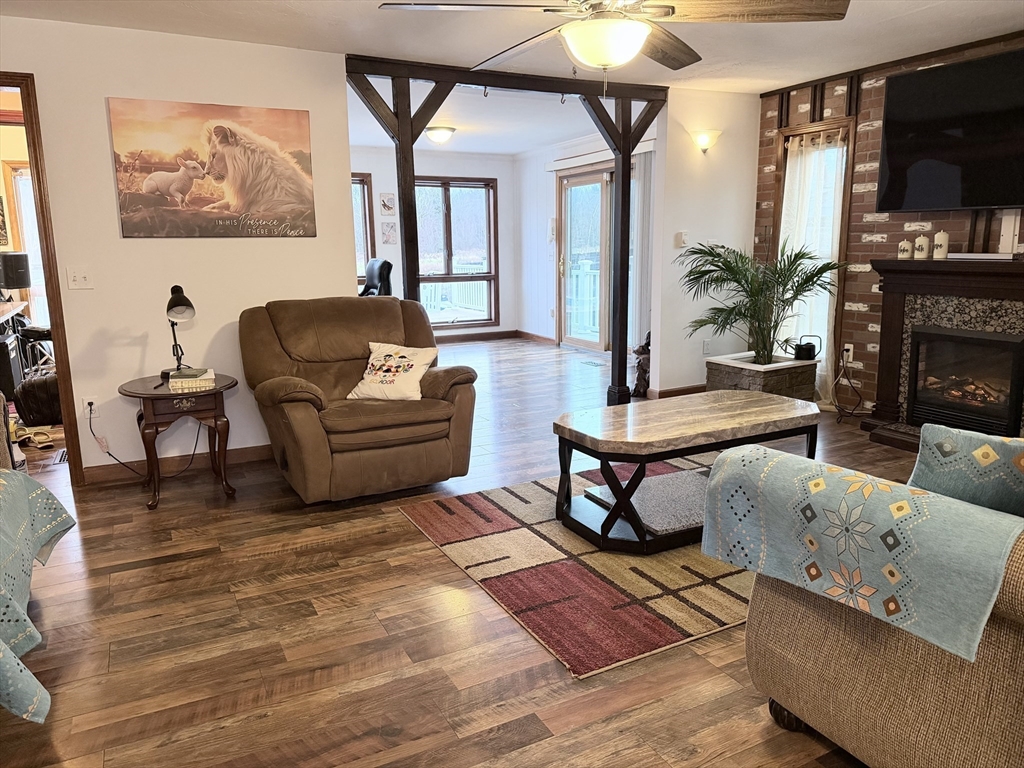 32 Hemlock Street Douglas, MA 01516 - Photo 4 of 11 a living room with furniture a flat screen tv and a fireplace