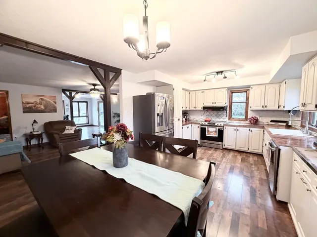 a kitchen with sink refrigerator and cabinets
